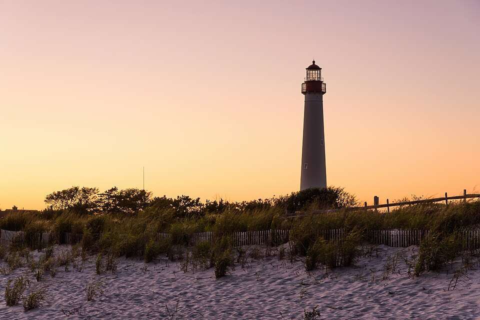 Cape May Lighthouse over the dunes at sunset